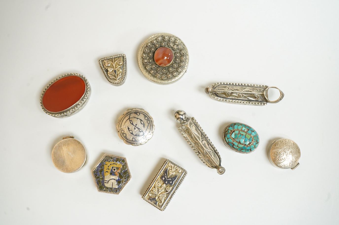 A collection of assorted pill boxes including one modern circular silver, a Mexican 925, six continental white metal, one inset with chalcedony and two with niello decoration and three other unmarked white metal pill box